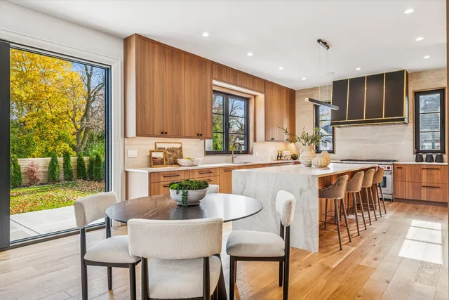 a white kitchen with a sink and a window