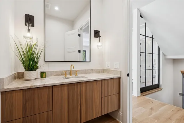 a bathroom with double vanity sinks and a mirror