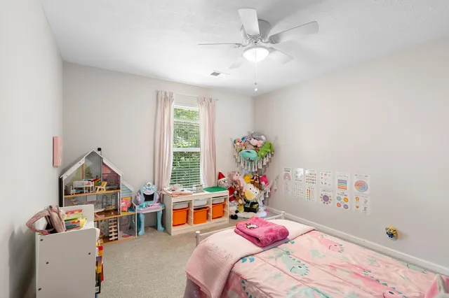 a bedroom with furniture a bed and a chandelier
