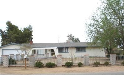 14795 Erie Road Apple Valley, CA 92307 - Photo 1 of 1 a front view of a house with a yard