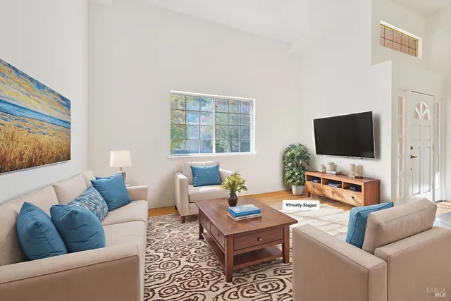 a bedroom with a bed and a painting on the wall