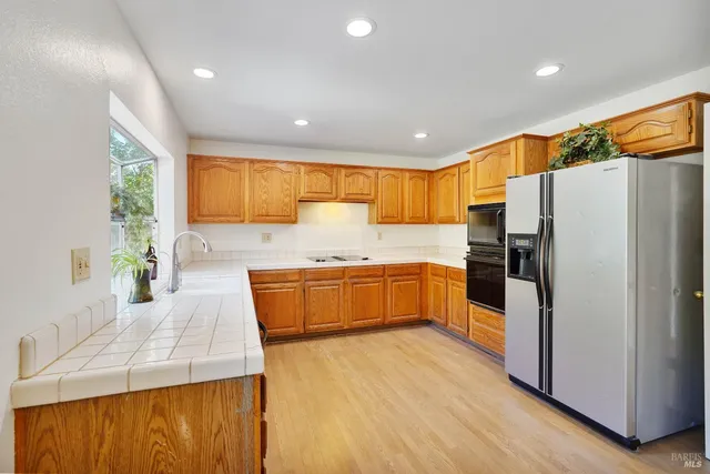a view of a patio with table and chairs and potted plants