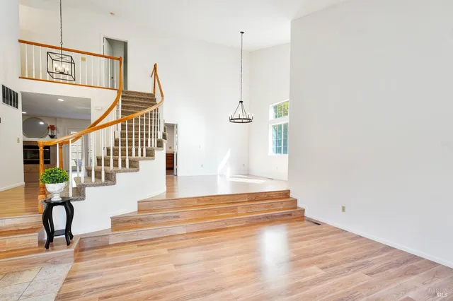 a view of a livingroom with furniture a fireplace and wooden floor