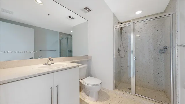 a bathroom with a sink toilet and shower