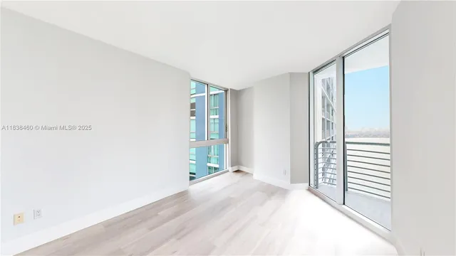 a view of a room with wooden floor and windows
