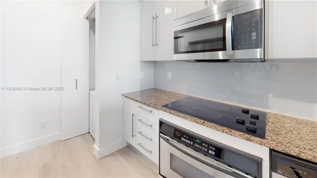 a kitchen with a stove and a microwave