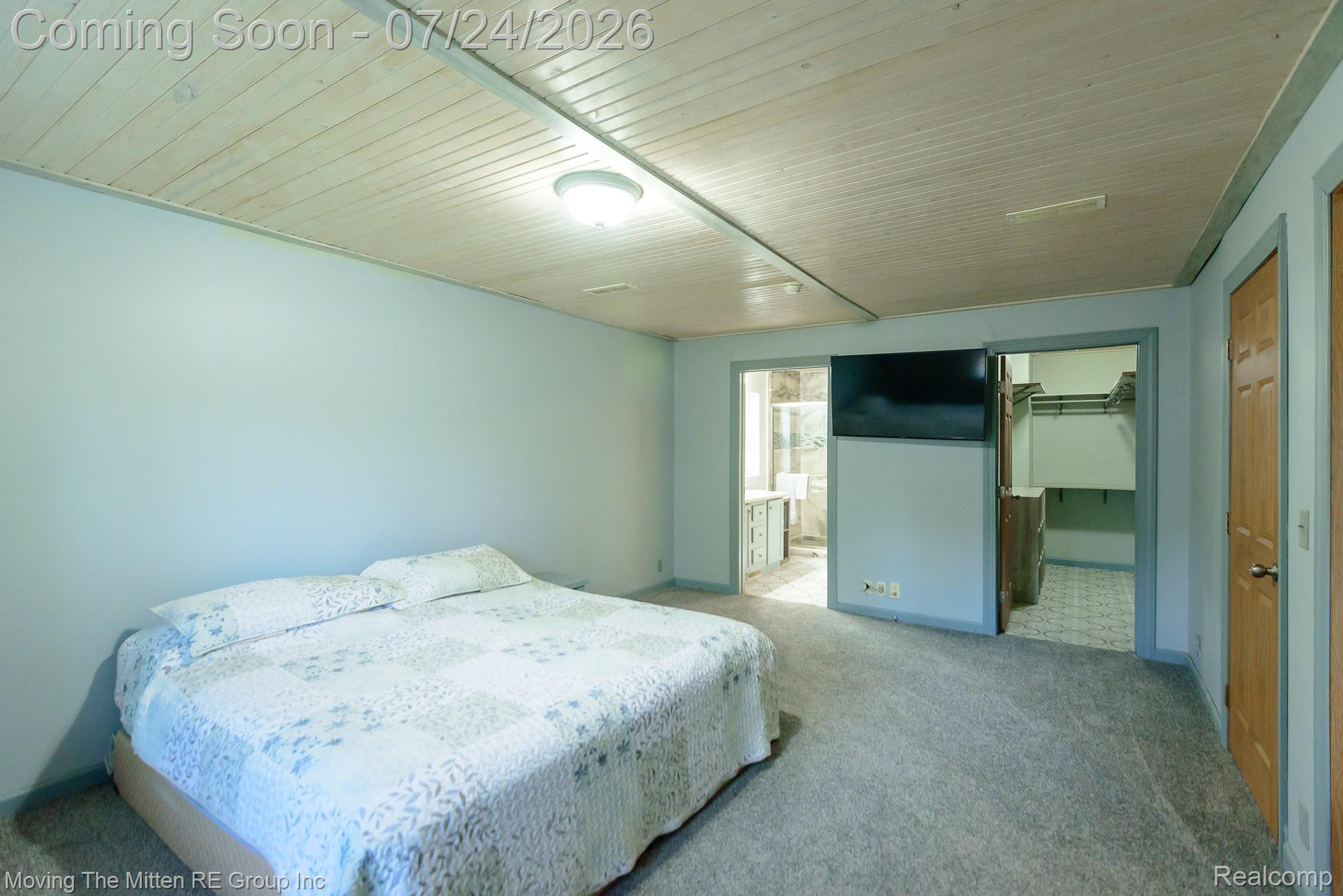 37460 Tyler Road Romulus, MI 48174 - Photo 25 of 52 Spacious room featuring light gray carpeting, a slatted wood-finish ceiling, and a flush-mount ceiling light