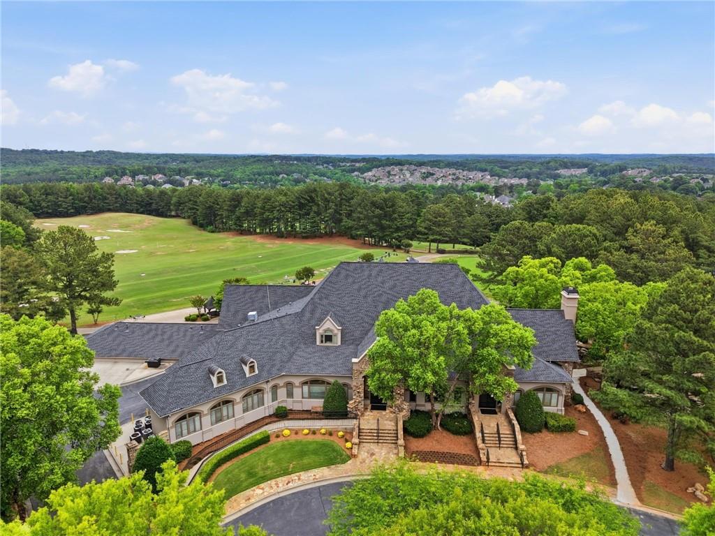 8340 Colonial Place Duluth, GA 30097 - Photo 72 of 74 an aerial view of a city with lots of residential buildings and mountain view in back