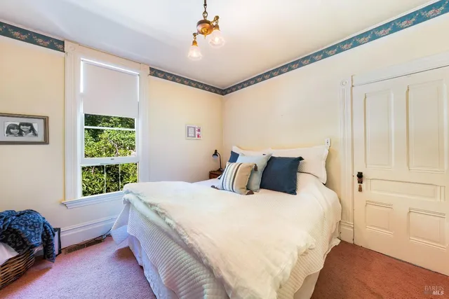 a bedroom with a bed couch and window