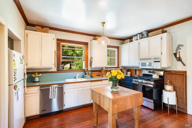 a kitchen with stainless steel appliances granite countertop a stove and a refrigerator