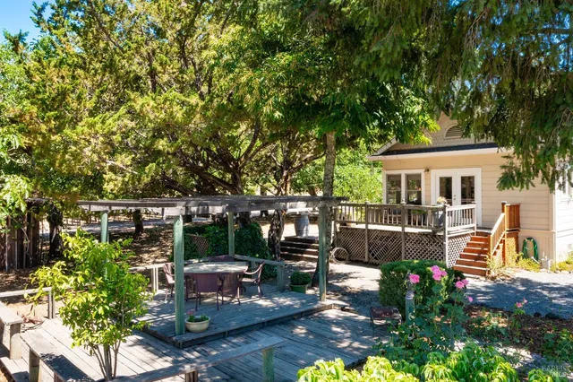 a view of a patio with couches table and chairs and potted plants