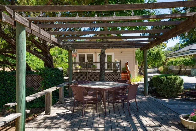 a view of a patio with table and chairs and potted plants