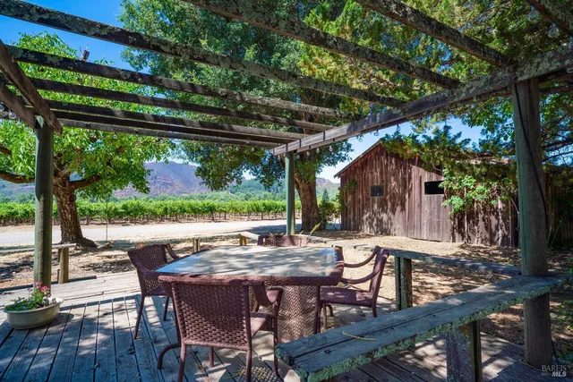 a view of patio with table and chairs and wooden floor