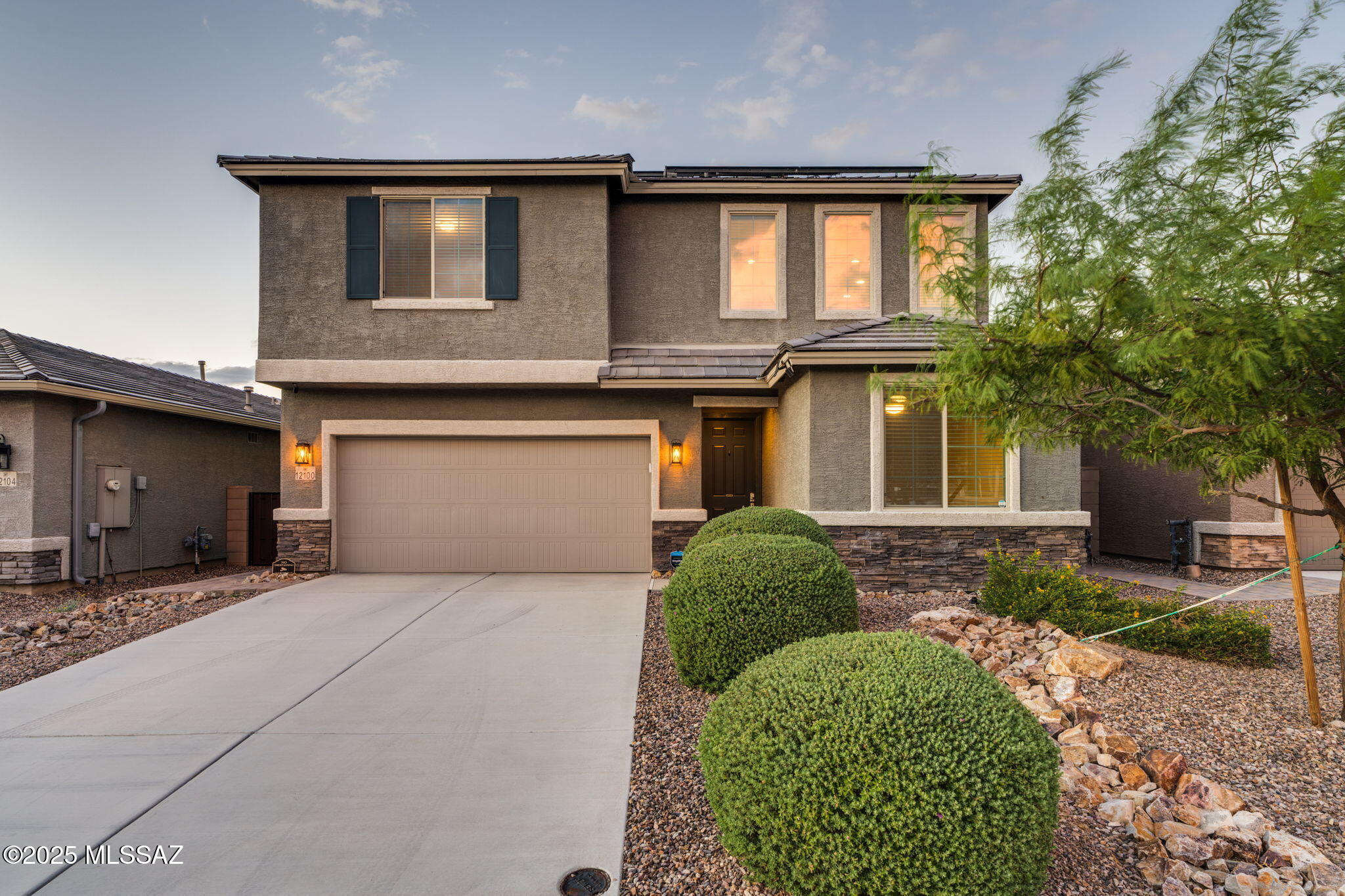 12100 East Ryscott Circle Vail, AZ 85641 - Photo 2 of 53 a front view of a house with a garden and parking space