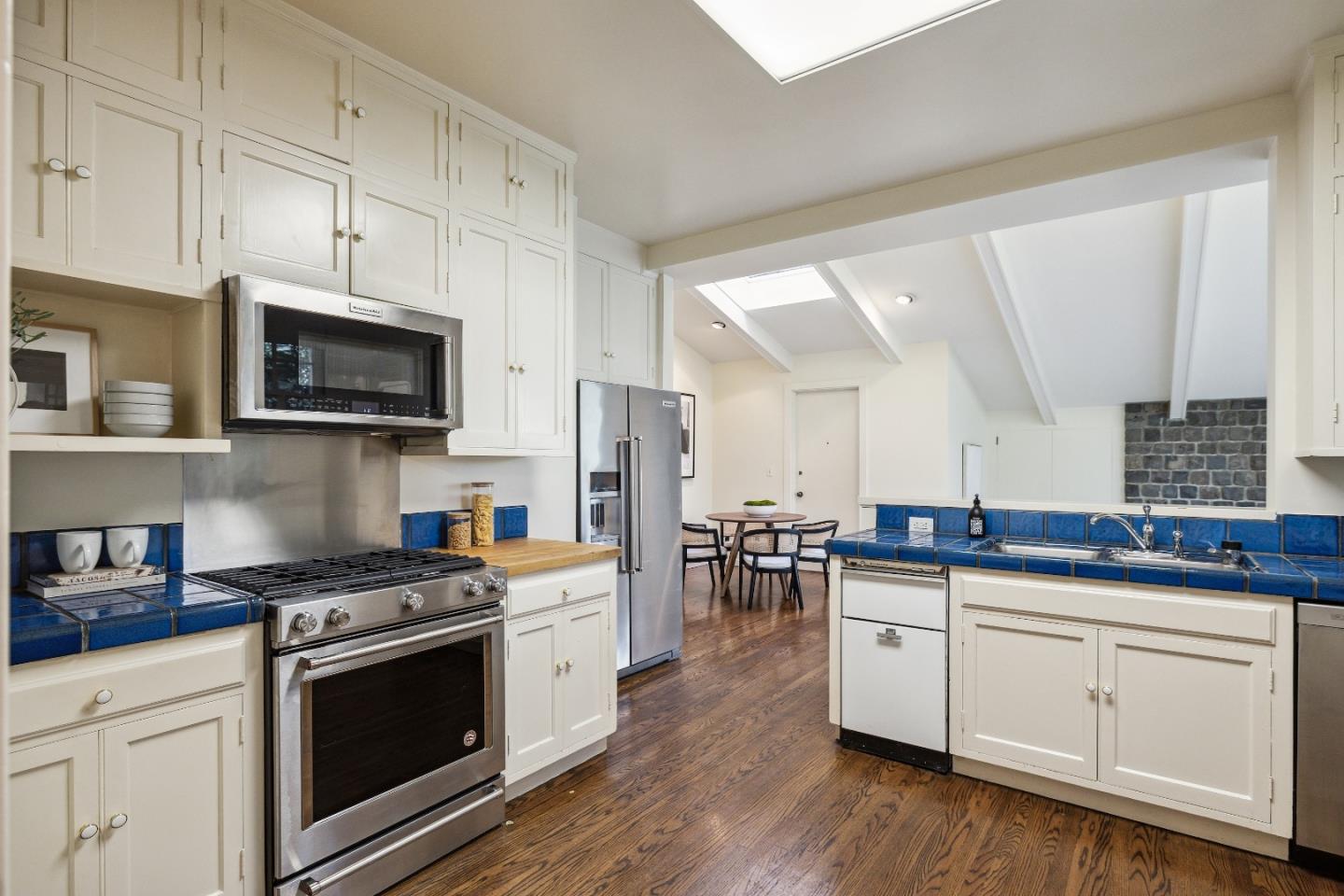 865 Culebra Road Hillsborough, CA 94010 - Photo 9 of 32 a kitchen with stainless steel appliances a white stove top oven and sink