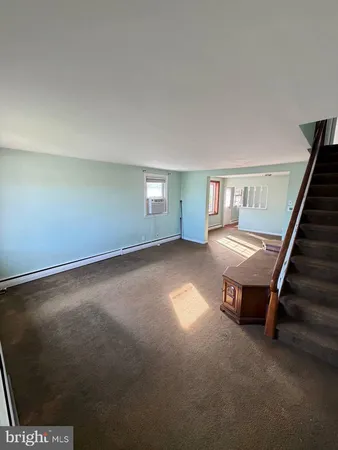 a view of an empty room with stairs