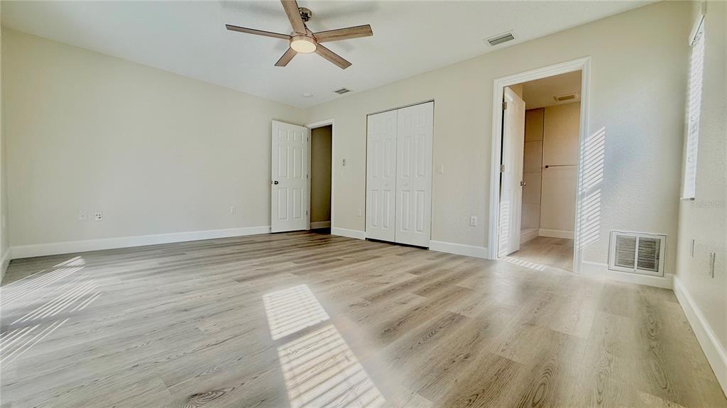 18917 Parade Road Hudson, FL 34667 - Photo 17 of 39 a view of empty room with wooden floor and fan