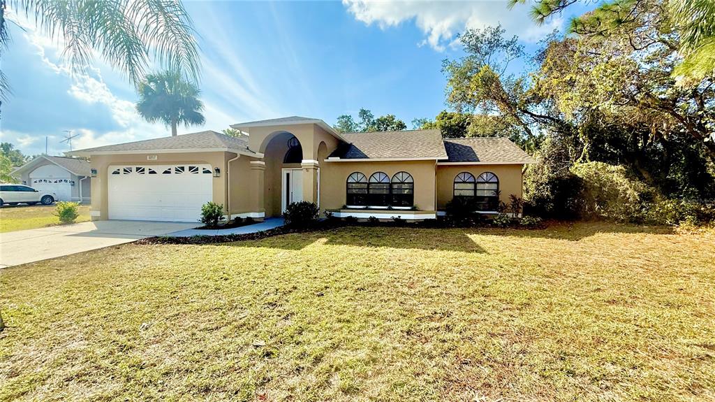 18917 Parade Road Hudson, FL 34667 - Photo 2 of 39 a front view of a house with a yard