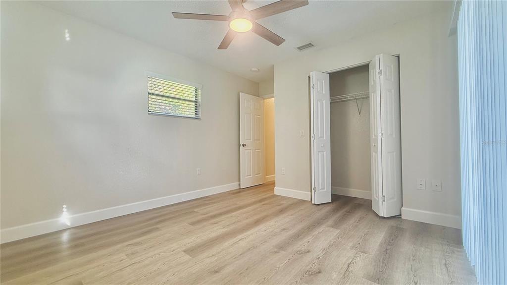18917 Parade Road Hudson, FL 34667 - Photo 24 of 39 an empty room with wooden floor and windows