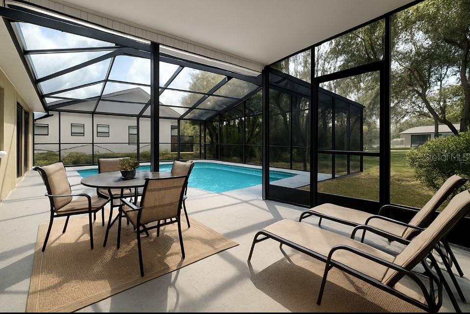 18917 Parade Road Hudson, FL 34667 - Photo 29 of 39 a view of a patio with a table and chairs