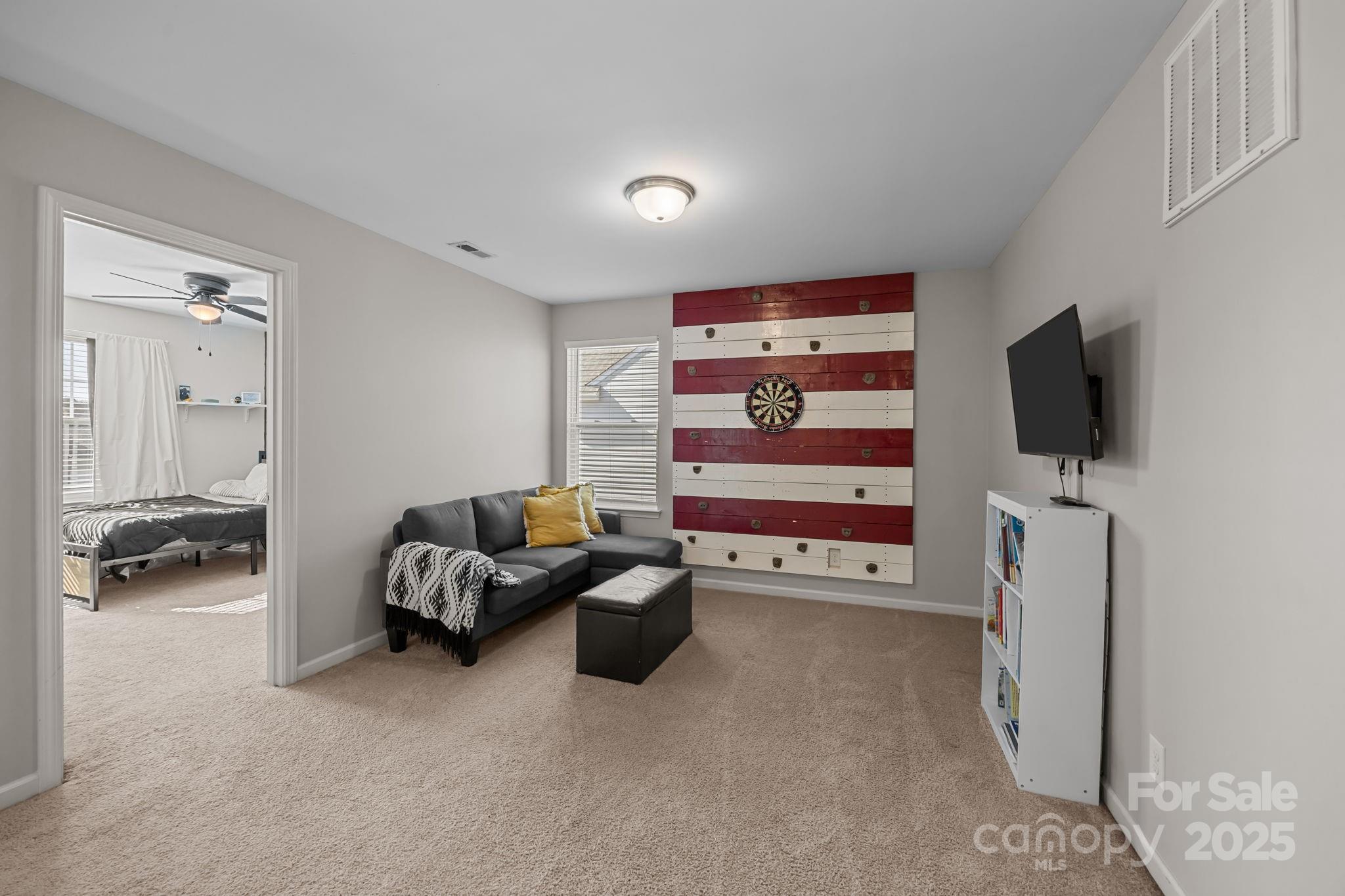 125 Devynn Ridge Court Mount Holly, NC 28120 - Photo 27 of 47 a living room with furniture and a flat screen tv