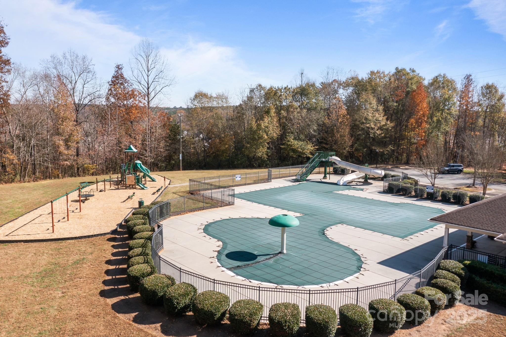 125 Devynn Ridge Court Mount Holly, NC 28120 - Photo 28 of 47 a view of a swimming pool with a yard