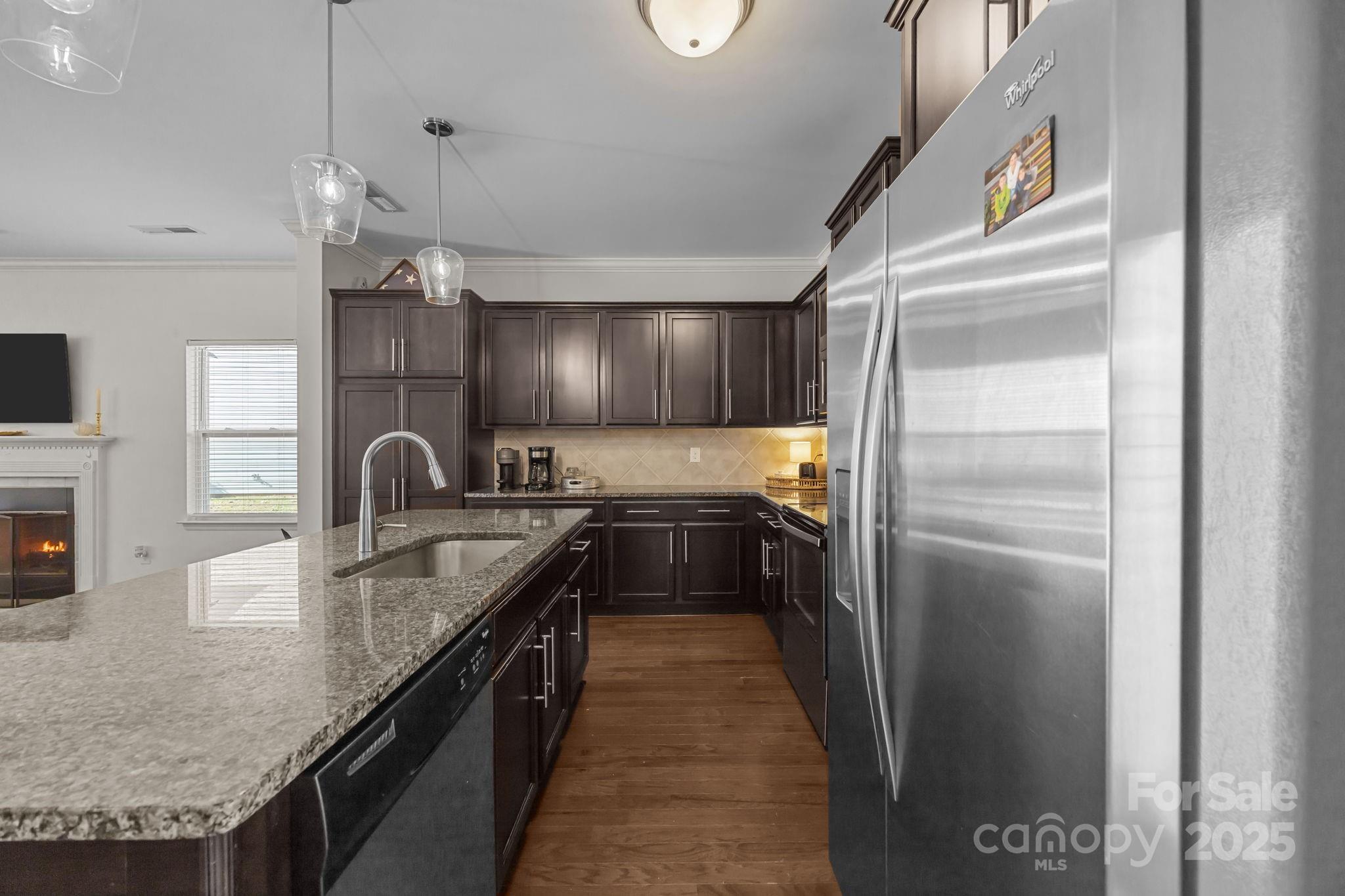 125 Devynn Ridge Court Mount Holly, NC 28120 - Photo 37 of 47 a kitchen with stainless steel appliances granite countertop a sink a stove and a refrigerator