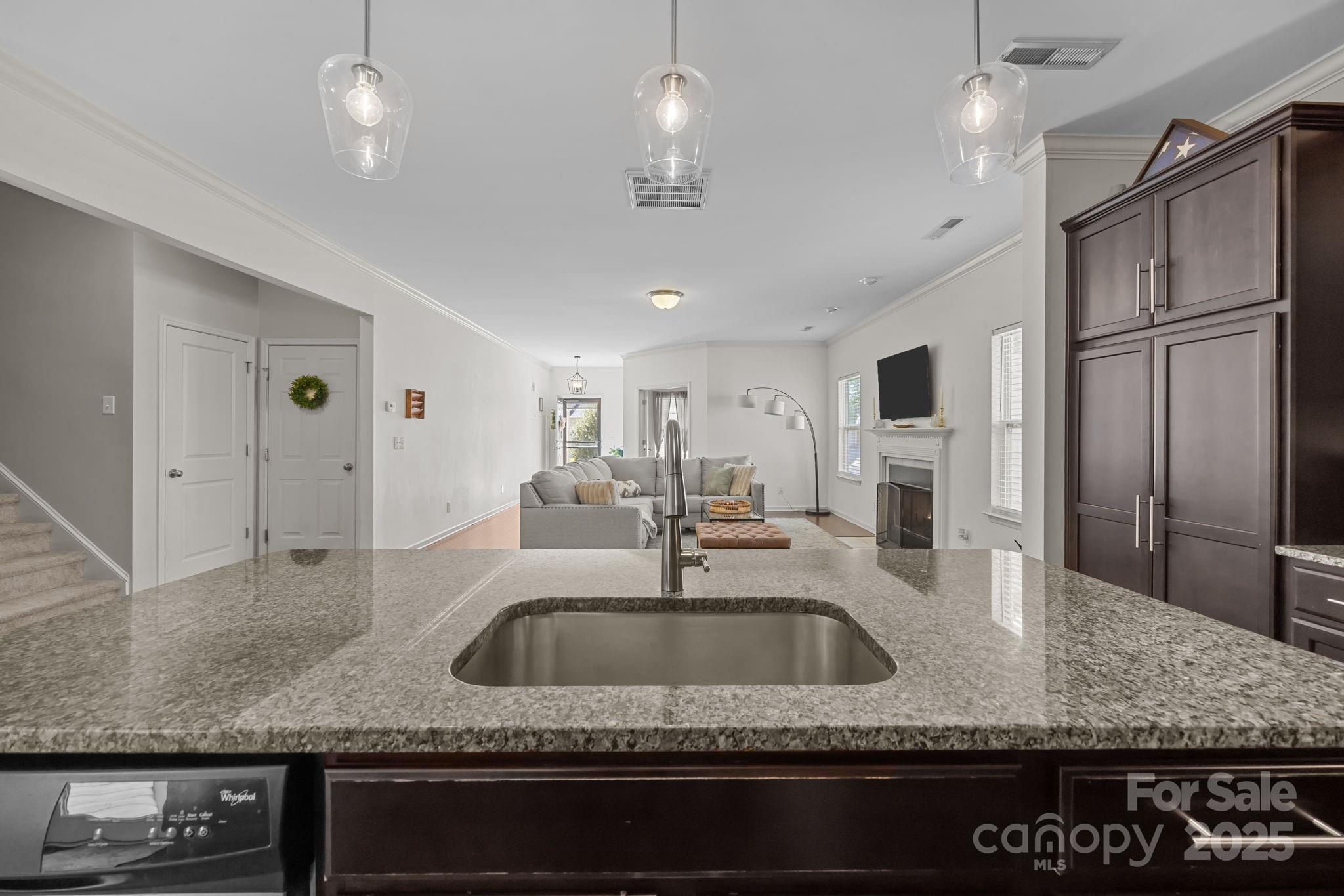 125 Devynn Ridge Court Mount Holly, NC 28120 - Photo 39 of 47 a kitchen with granite countertop a sink stainless steel appliances and a counter top space