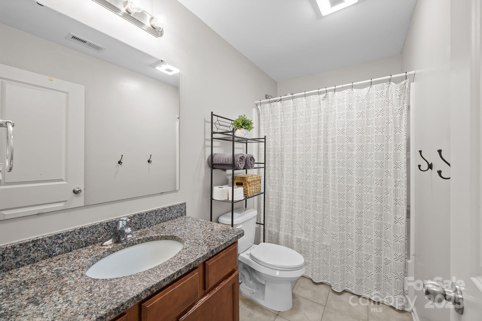 125 Devynn Ridge Court Mount Holly, NC 28120 - Photo 43 of 47 a bathroom with a granite countertop sink toilet and shower