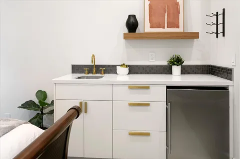 a kitchen with a sink and a potted plant