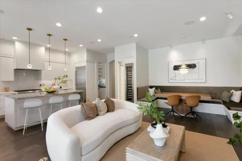 a living room with furniture kitchen view and a potted plant