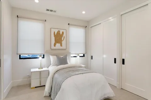 a bedroom with bed and a closet