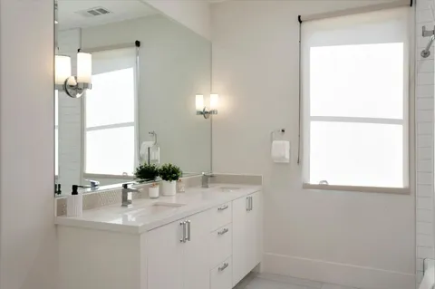 a bathroom with a tub shower and sink