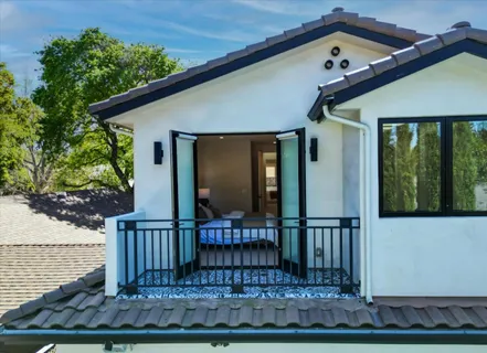 a front view of a house with glass windows and door