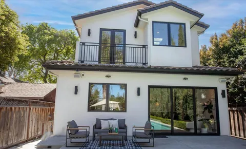 a view of house with yard outdoor seating and barbeque oven