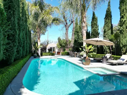 a view of a patio with table and chairs and potted plants