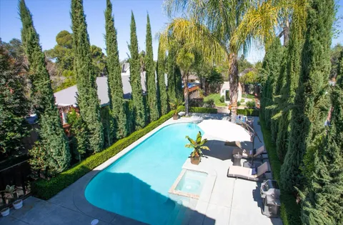 a view of house with outdoor space and sitting area