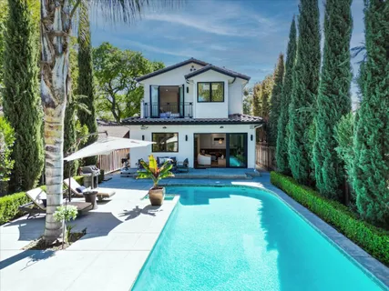 a view of a garden with wooden fence