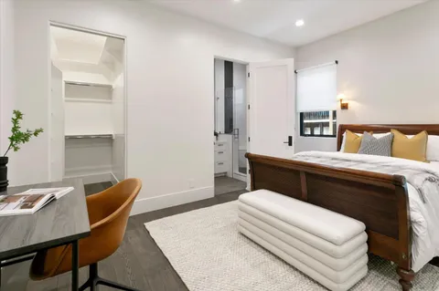 a bedroom with a bed and a table in it