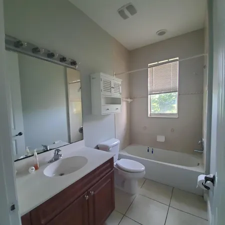 a bathroom with a sink toilet tub and shower