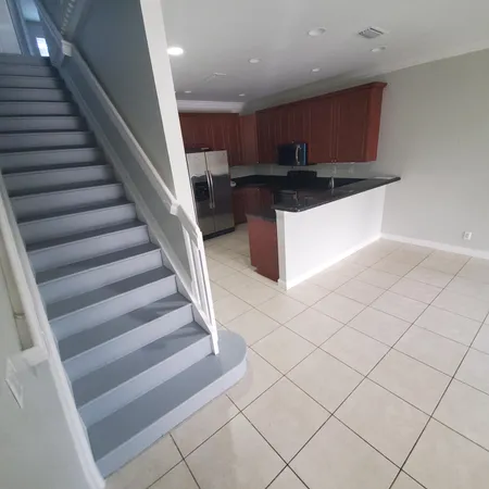 a view of kitchen with cabinets and window