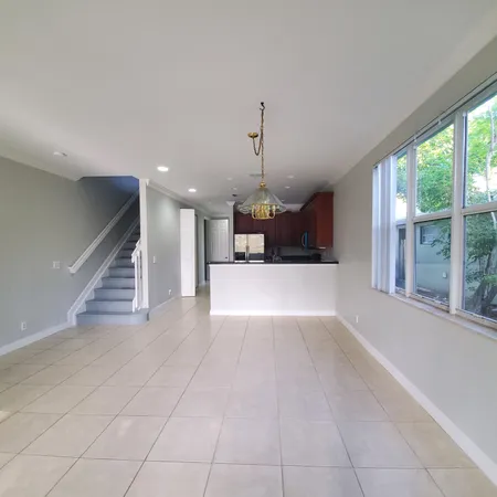 a view of a kitchen with a sink and a window