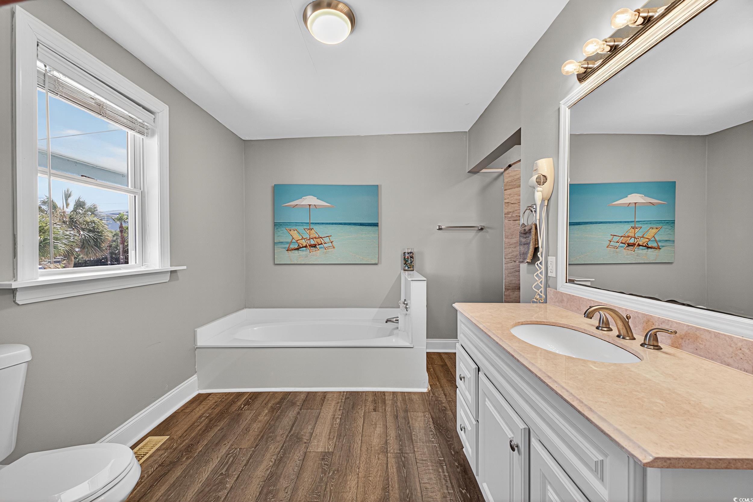 1885 Pompano Drive Murrells Inlet, SC 29576 - Photo 12 of 34 Full bath featuring wood finished floors, a garden tub, and vanity