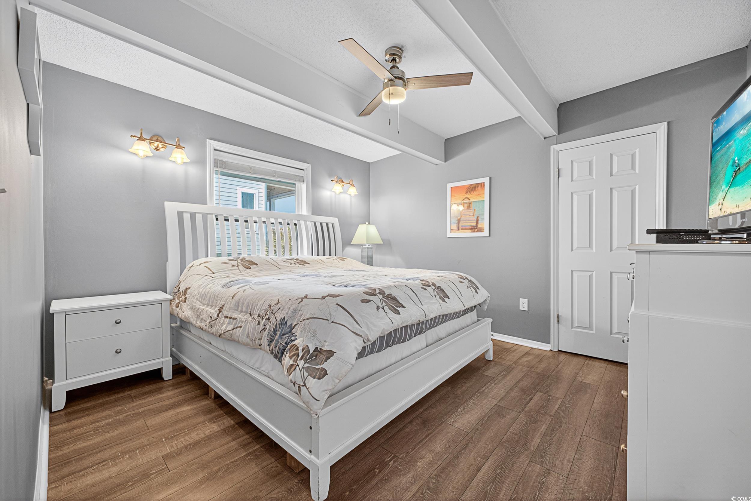 1885 Pompano Drive Murrells Inlet, SC 29576 - Photo 17 of 34 Bedroom featuring wood finished floors, beam ceiling, and ceiling fan