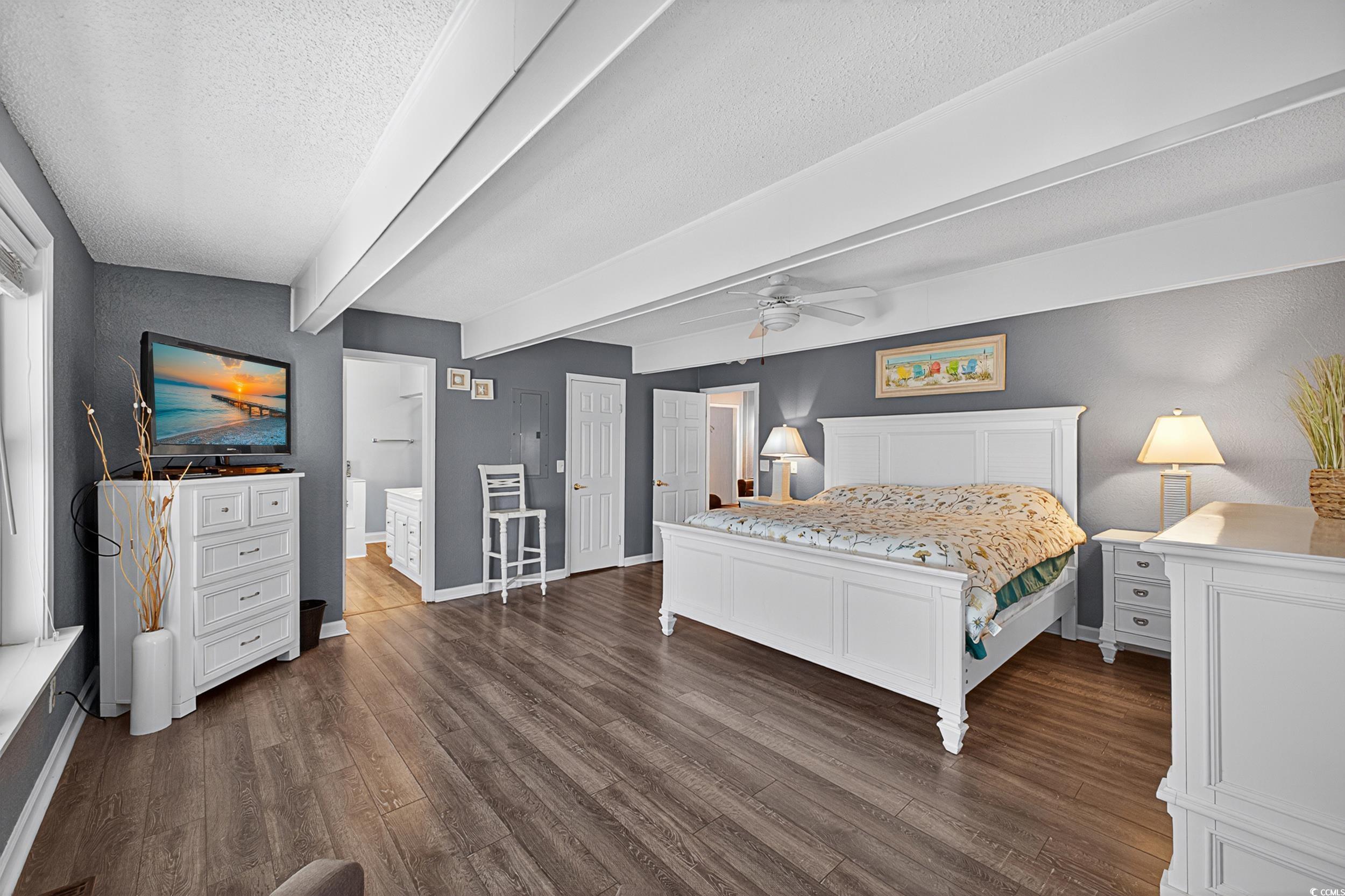 1885 Pompano Drive Murrells Inlet, SC 29576 - Photo 18 of 34 Bedroom featuring a textured ceiling, dark wood-style floors, beamed ceiling, ensuite bath, and a ceiling fan
