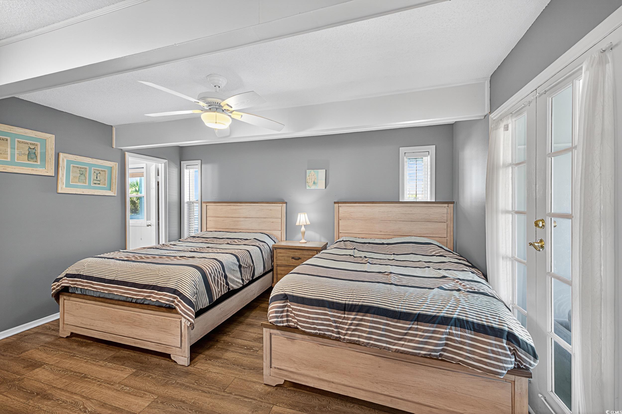 1885 Pompano Drive Murrells Inlet, SC 29576 - Photo 19 of 34 Bedroom with wood finished floors, multiple windows, and a ceiling fan