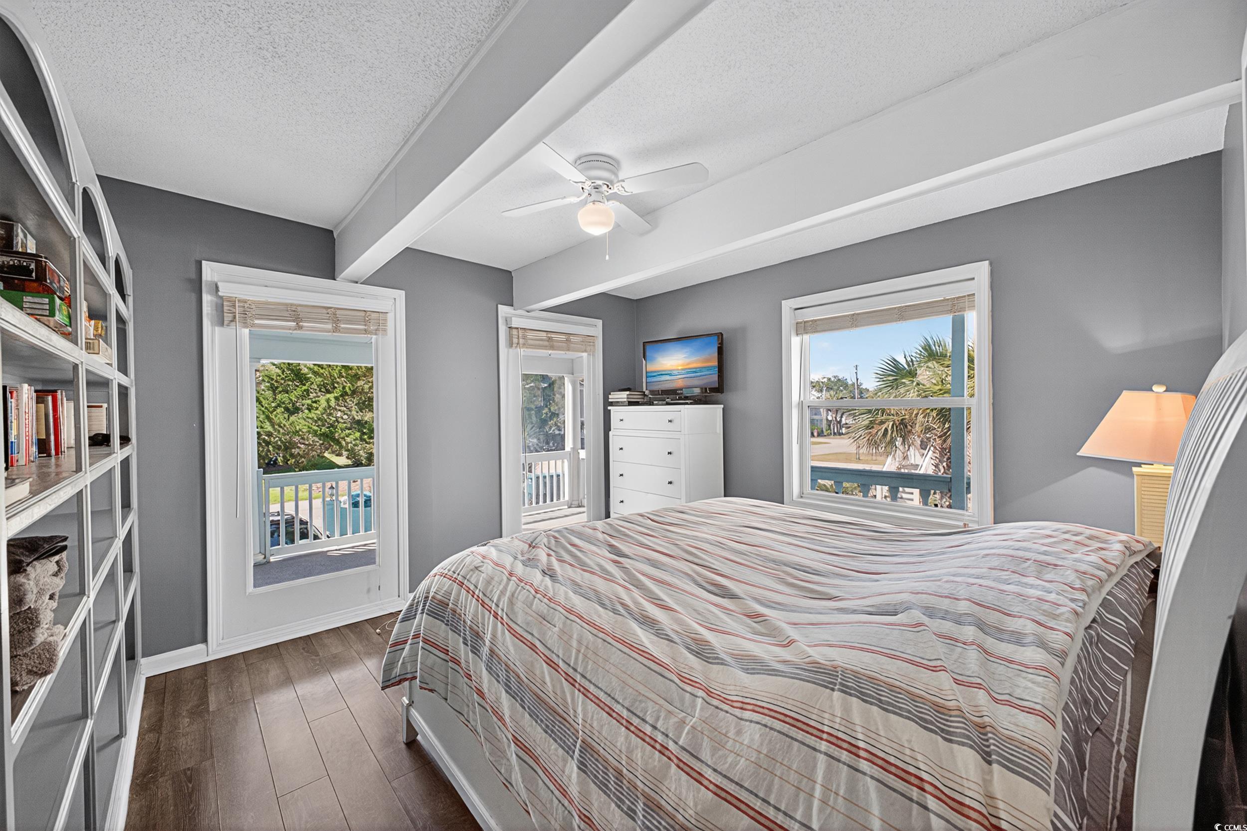 1885 Pompano Drive Murrells Inlet, SC 29576 - Photo 23 of 34 Bedroom featuring dark wood finished floors, a textured ceiling, and a ceiling fan