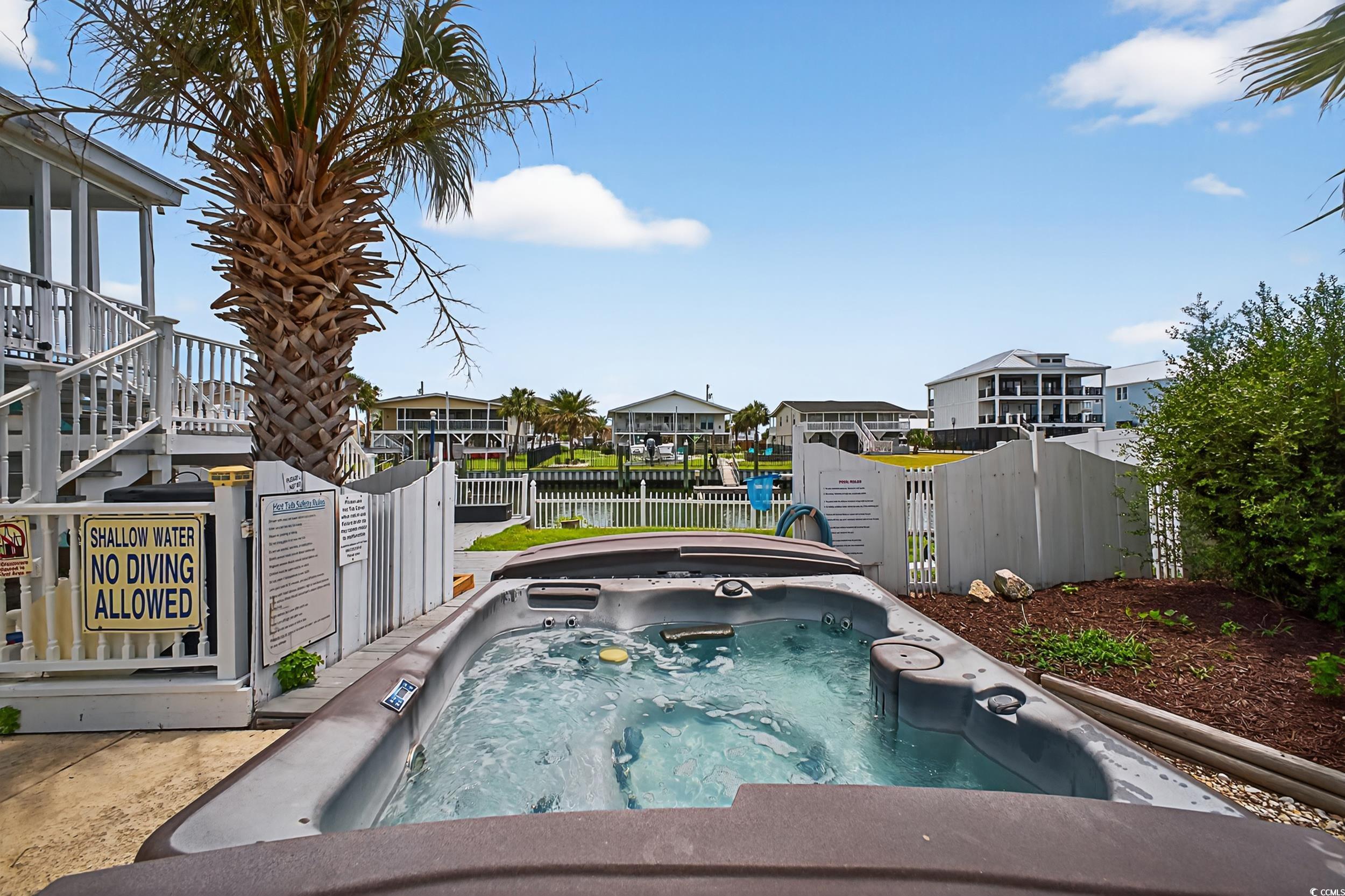1885 Pompano Drive Murrells Inlet, SC 29576 - Photo 32 of 34 View of swimming pool with an outdoor hot tub, a water view, and a residential view