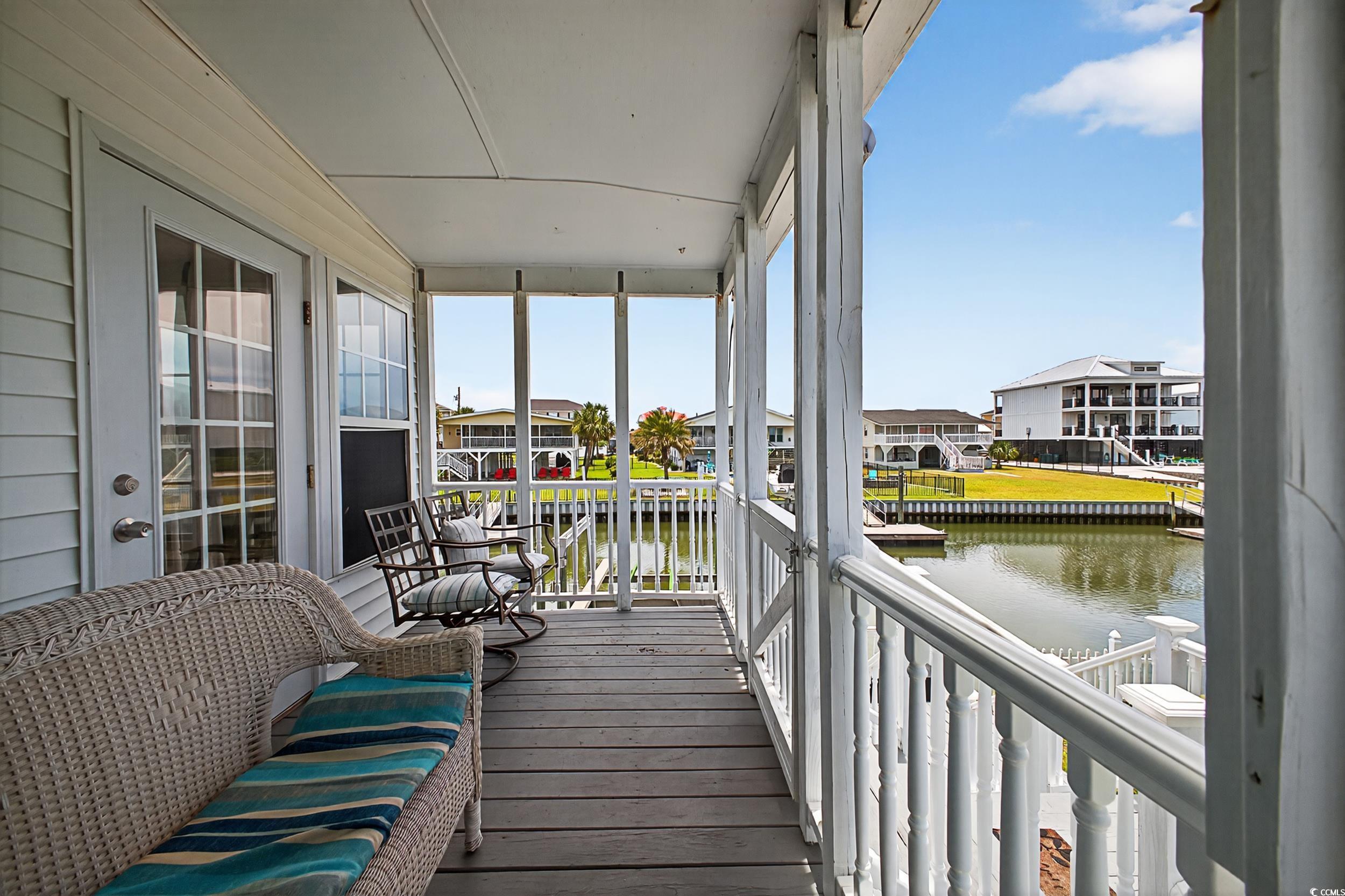 1885 Pompano Drive Murrells Inlet, SC 29576 - Photo 6 of 34 Sunroom / solarium featuring a water view and a residential view