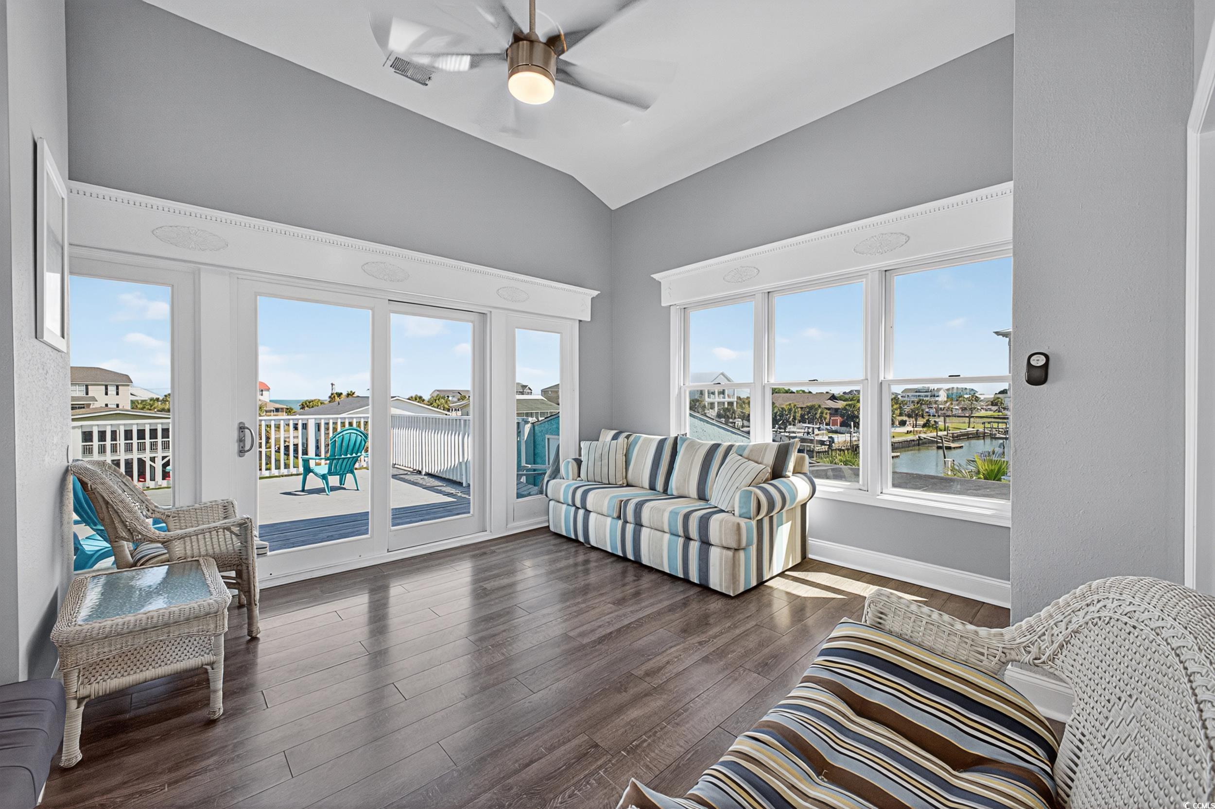 1885 Pompano Drive Murrells Inlet, SC 29576 - Photo 10 of 34 Living room with a water view, vaulted ceiling, dark wood-style flooring, and a ceiling fan
